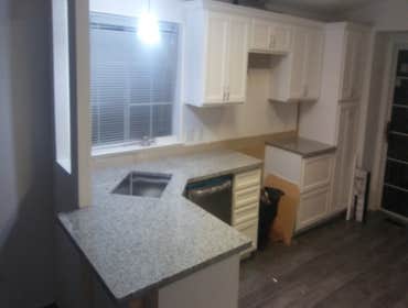 Photos by Expression Stone Construction #1 New white shaker cabinets,stainless steel undermount kohler sink and faucet,3cm super white granite
