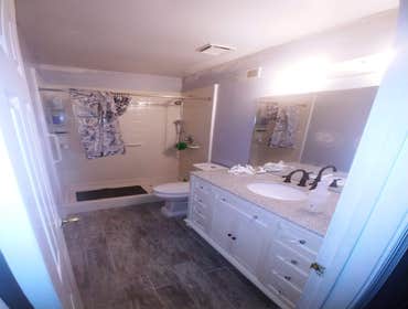 Photos by Pro 1 Home Improvements #10 New sub floor.
Granite top vanity
Ceramic tile planks.