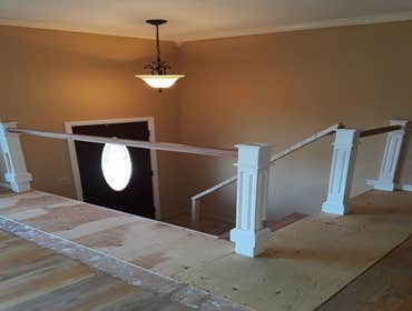 New Stairs Project in Hudson, Ma Brazilian Cherry Stairs with Railings and Metal Balusters and White Newels
