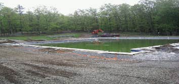 Trails End Shohola Pool Removal of all concrete around pool complete prep of site, and repour over 150 yards of concrete around olympic size pool for T