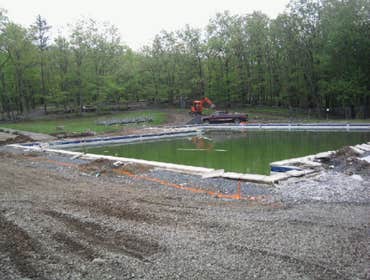 Trails End Shohola Pool Removal of all concrete around pool complete prep of site, and repour over 150 yards of concrete around olympic size pool for T