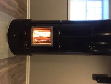 Photos by Grz LLC #2 Masonry Heater, Stove is a modern heat-storing and metal plated fireplace that represents classic Scandinavian design. With an eff