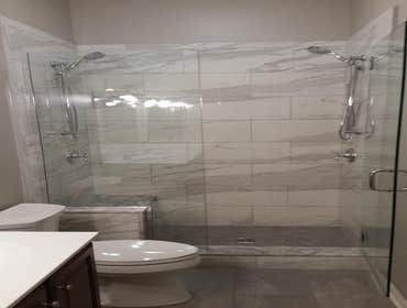 Photos by Custom Kitchen and Bath Works, Inc. #1 Two bathroom remodeling project.
Master bathroom shower, tile floor, and wood trim.
Hall bathroom sh
