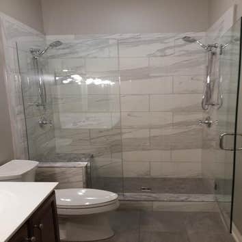 Photos by Custom Kitchen and Bath Works, Inc. #1 Two bathroom remodeling project.
Master bathroom shower, tile floor, and wood trim.
Hall bathroom sh