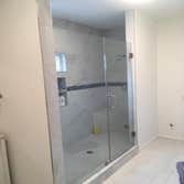 Photos by Ray's Remodeling & Construction #1 Redid cabinets did quartz walk-in shower with double faucet and bench!