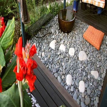 Landscape Design To maximize organic gardening space and extend the growing season in a narrow city lot, biota uses laser-cut Core-ten steel for raised