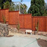 6' high good neigbor fence with 12" square lattice top This is a beautiful, outdoor kitchen we built for a client in Irvine, California. We collaborate