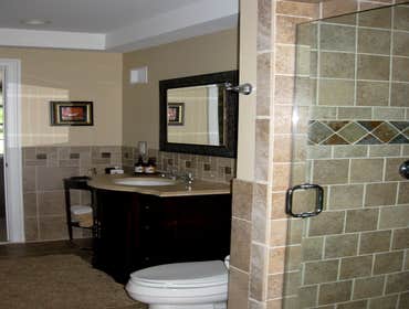 Guest Bath Handicap accessible full bath. originally built in 1950, this completely renovated bath is spacious with 3/4 height floor to ceiling tile,