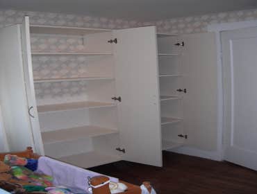 Stone House Remove cabinets and window, add wall closet to bedroom, install sliding door, tile on inside of slider, add secound story deck to front of 