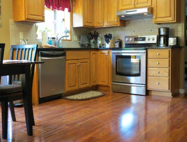 A family's living room and kitchen installed with laminate This project started out with us removing the old existing carpet in the living room and old