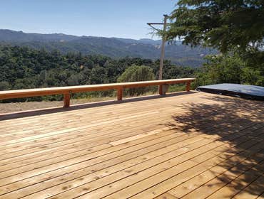 Deck and Hot Tub Clients requested a large deck added to their back yard with hot tub plus bench surrounding the existing tree. Designed and built by 
