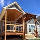 Fall Brook Patio Large multi-level deck with a portion of it covered by a solid cover and the other with a large pergola.