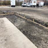 Nelsons Catering Added on existing concrete pad, set forms, and poured new concrete. Reason for new concrete was area kept flooding out when it would r
