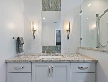 Bromley Seaside Master Bath Inspired by contemporary lines and the blues and greys of the ocean, this seaside master bathroom features pearlescent mosa