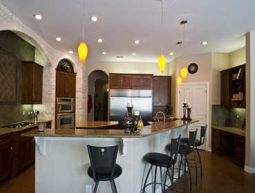 Bastrop, TX Custom Home We designed the electrical portion of this beautiful dream kitchen. Note: above cabinet and under cabinet lights as well as c