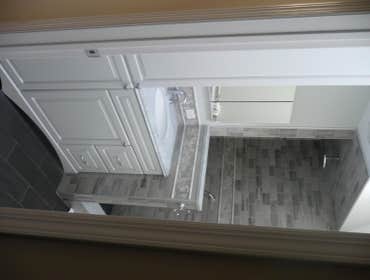 BATHROOM RENOVATION #1 Take a standard bathroom and renovate:
-Enlarge shower to the extent possible
-Cut out half of the shower wall and use glass t