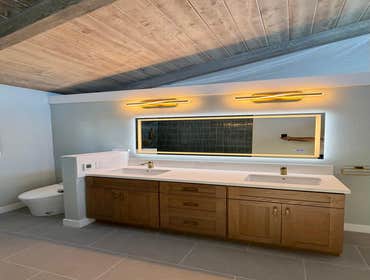 Photos by Ma Properties Construction #1 This bathroom remodel transformed an outdated space into a modern, functional retreat. The project included a c