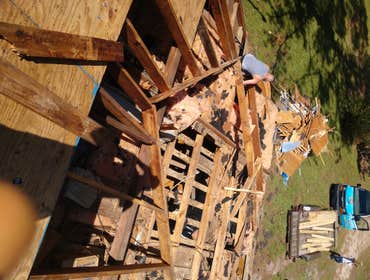 Photos by Service Restoration Pros LLC #1 A tree fell through the roof of this 3 bedroom house during Hurricane Ida. It left several gaping holes and a