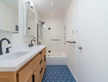 Bathroom Addition | Campbell This Campbell bathroom addition blends a modern barn–inspired aesthetic with warm, natural elements. The design features l