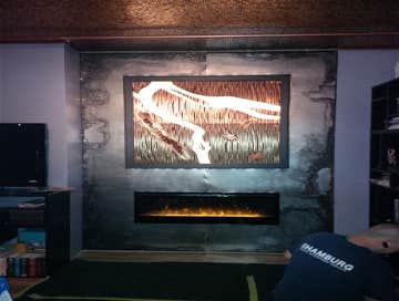 Shamburg Heating LLC Project Before and after a fireplace installation with mantle and cabinets.