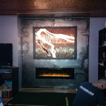 Shamburg Heating LLC Project Before and after a fireplace installation with mantle and cabinets.