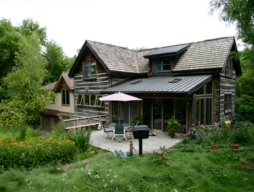 Addition & remodel, Barrington Hills Design/build master suite, office & 3 car garage addition onto a historic 1850’s hand hewn log home. Use of stone,