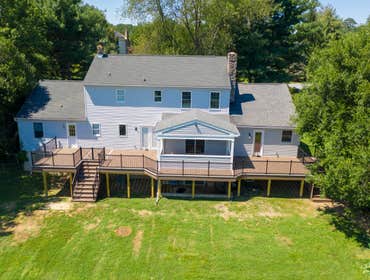 Photos by Iron Ridge Contracting LLC #5 New deck construction with integrated covered roof structure, including design consultation, 3D renderings, and