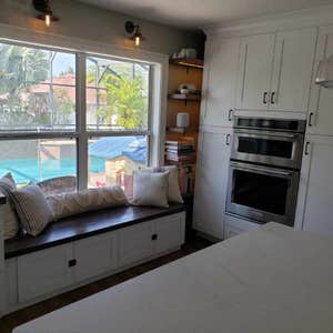 Photos by Jmc Builders Group LLC #1 Complete tear out and remodel with white shaker cabinets , custom oak shelving and bench