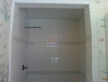 Master shower Bathroom shower remodel. 3x6 tile on subway pattern with glass liner. Shampoo niche and soap niche and seat also installed.