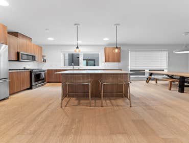 Kevin | Kitchen This kitchen remodel features new white quartz countertops, an under-mount stainless steel sink with a modern faucet, and light-toned h