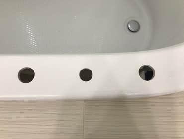 Bathtub Repair The homeowner chose to relocate plumbing fixtures - Original installation holes were properly supported and the repair area was refinish