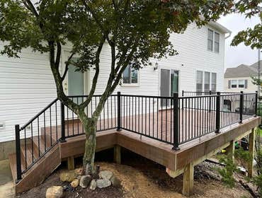 Photos by Pristine Construction #13 Removed old wooden deck and replaced with a beautiful brown composite deck with black aluminum railing