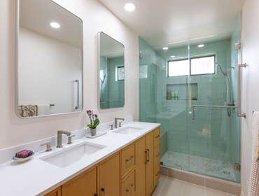 Laurel Stylish Bathroom Remodels Transform your daily routine with these two stunning bathroom renovations. Featuring sleek double vanities, vibrant aq
