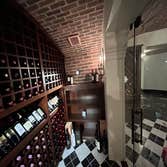Photos by Andy James Heating LLC Beautiful custom wine cellar. Natural and timeless cherry wood racks and marble tile. Fully encapsulate with an air sp