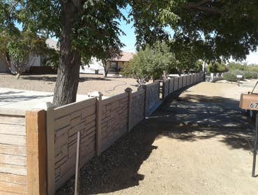 EchoStone Remove wood fence and install new EchoStone with a custom 20ft gate.