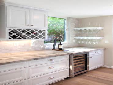 Dreamy Carlsbad Kitchen & Outdoor Living Indoor/outdoor kitchen remodel including new La Cantina four-panel door, trellis over outdoor seating area and