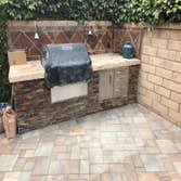 Photos by Home Improvement Projects #3 outdoor firepit, built in grill, pavers and turf