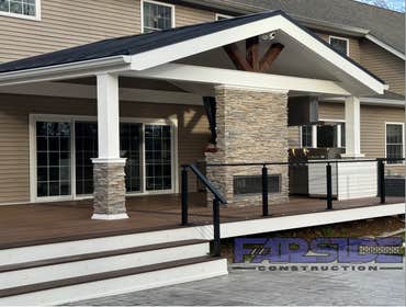 Photos by Farside Construction LLC #1 Newly constructed covered deck with standing seam cathedral style gable roof. Excavated and built a walk out egre
