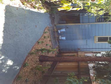 Restored Bayview Backyard Repurposed paver patio, woodland landscape, gray fines pathway, irrigation.