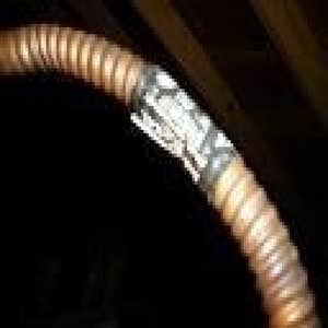 Copper water heater pipe beginning to show black corroding sulfur