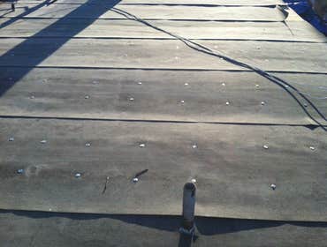 Flat Roof Ponds Water But Doesn't Leak: 10 Yr Guarantee!! In a perfect world there would have been money in the budget to create a slope on this home..