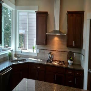 Kitchen remodel cabinets, countertops, fixtures, island, installation of appliances and vent hood