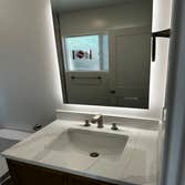 Project 522 Renovation of 2 full baths including materials and modification of exterior door to a full wall and a window