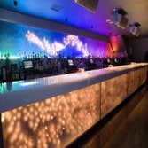 Bar illuminated by touch