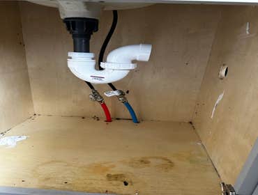 Photos by Des in the Cut Construction Company #1 We replaced a plastic, double-sink drain with pvc pipes, two P-traps and installed a vent so the water