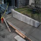Project photos from Hollis Contracting Tore out the original concrete
Built a 30 foot high solid block wall
Repoured the parking pad and side walk alo