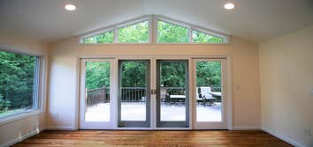 Caldwell Project Kitchen renovation, sunroom and deck additions to a contemporary house. The wall between the kitchen and dining room was removed to cr