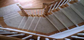 Custom Runners Custom runner installed on a winding stair case, and back set of steps with angled landings.