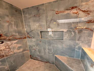 Photos by Sommer Contracting Group #3 2ftx4ft marble wall tile, 8x48 ceramic floor tile. New remodel can lighting, 3cm Quartz countertops with new Bert