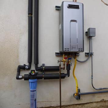 Tankless water heater installation Rinnai 9.4 tankless water heater, exterior installation on a slab foundation